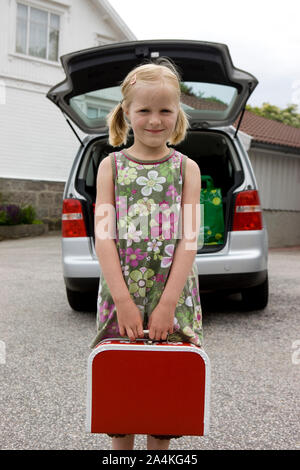 Girl waiting to travel by car Stock Photo