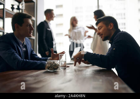 two creative guys sharing ideas of successful business. close up side view photo employees making decision Stock Photo