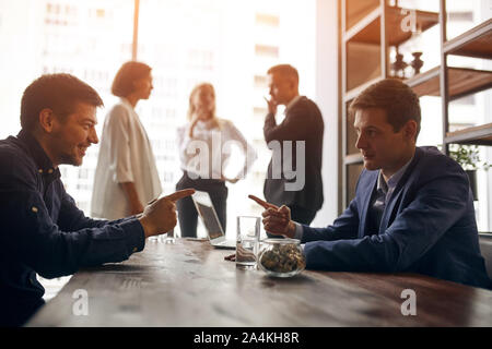 two funny businessmen make bet, friendly argument between colleagues. close up side view photo. Stock Photo