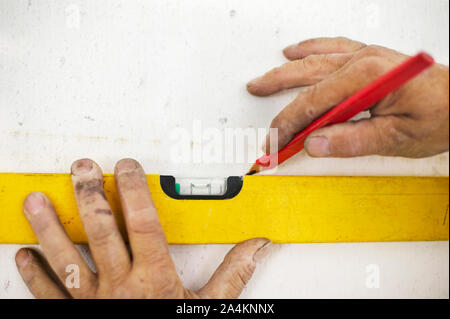 Using a level and pencil Stock Photo