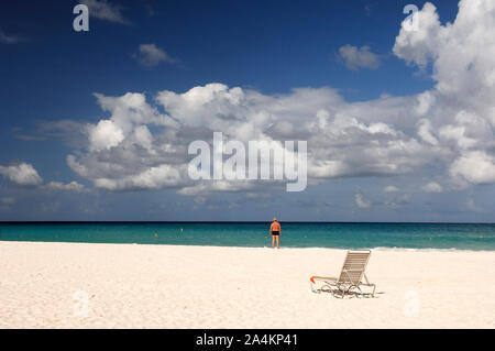 Man and beach chair at Manchebo Beach, Aruba Stock Photo