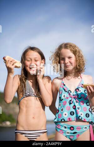 Girls eating hot dogs, Norway Stock Photo - Alamy