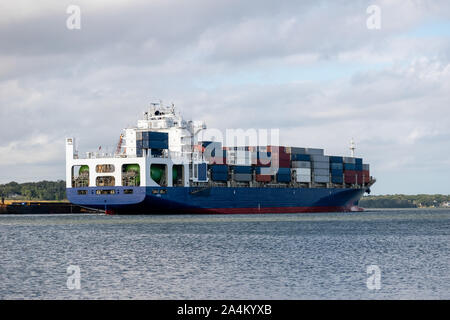 Large cargo container ship passing through river. Stock Photo