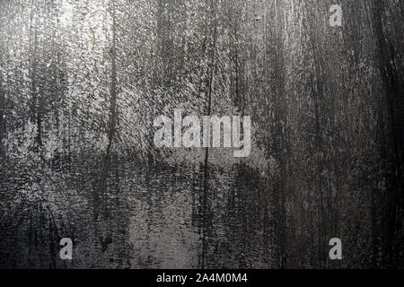 Old cemented wall with black and gray rough texture, rough background Stock Photo