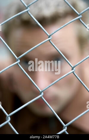 Behind a wire fence - locked up Stock Photo