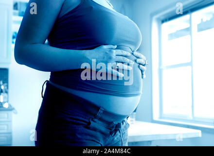 Pregnant Woman in Kitchen Stock Photo