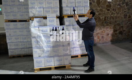 Rommani, Morocco. 11th Oct, 2019. Mamoun Sayah, general manager of Morocco's agricultural company Red Farm, checks the package of the wine in Rommani, Morocco, Oct. 11, 2019. As Chinese consumers are looking for high-quality imported goods, China International Import Expo (CIIE) is undoubtedly a rare opportunity for Moroccan companies interested in expanding their exports, said Mamoun Sayah, general manager of Morocco's agricultural company Red Farm.TO GO WITH 'Feature: Moroccan winery aims to expand Chinese market via 2nd import expo in Shanghai' Credit: Chen Binjie/Xinhua/Alamy Live News Stock Photo