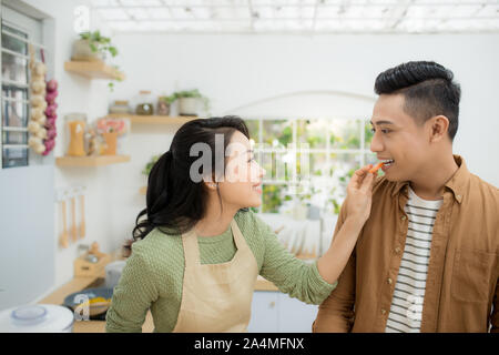 Attractive couple is cooking on kitchen. Stock Photo