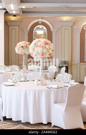 Luxurious wedding decor at the dining tables in the restaurant 's bright hall Stock Photo