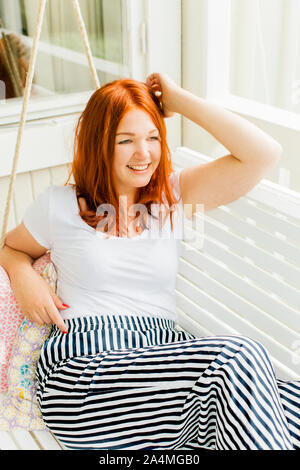 Woman resting in swing Stock Photo