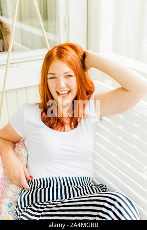 Woman laughing in swing Stock Photo