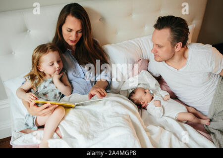 Family together in bed Stock Photo