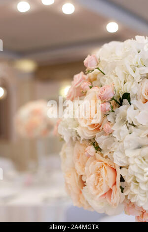 A close up bouquet of flowers on the wedding table. Beautiful round bouquet. Stock Photo