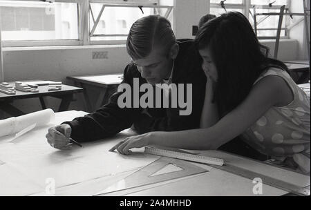 1964, historical, two college students - a young man and a young women - sitting together in a design & construction class at the University of Southern California, USA. working as a team on some technical drawings. Stock Photo