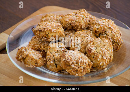 Homemade oatmeal cookies with coconut chips, muesli, dried apricots and other delicacies. Sweet and healthy snack, Stock Photo