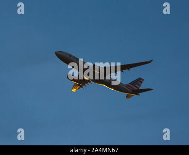 CHARLOTTE NC (USA): October 11, 2019 - An American Airlines commercial airliner flies at low altitude after taking off at sunset. Stock Photo