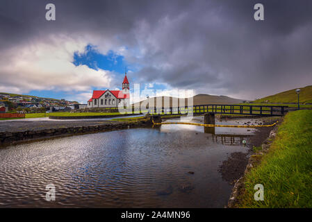 Church and the river Stora located in Sandavagur on Faroe Islands, Denmark