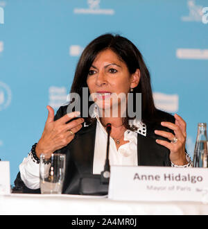 COPENHAGEN, DENMARK – OCTOBER 09, 2019: Mayor of Paris, Anne Hidalgo, retiring Chair of the  C40 World Mayors speaks during the C40 World Mayors Summit opening press conference at Copenhagen City Hall. More than 90 mayors of some of the world’s largest and most influential cities representing some 700 million people meet in Copenhagen from October 9-12 for the C40 World Mayors Summit. The purpose with the summit in Copenhagen is to build a global coalition of leading cities, businesses and citizens that rallies around radical and ambitious climate action. Also youth leaders from the recent Cli