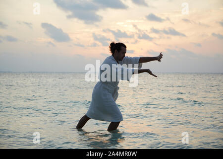 Man doing yoga Stock Photo
