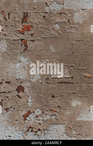 Old ruined and cracked wall made of red bricks with remains of plaster. Stock Photo