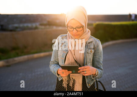 Young woman using digital tablet Stock Photo