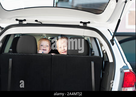 Smiling boy and girl in car Stock Photo