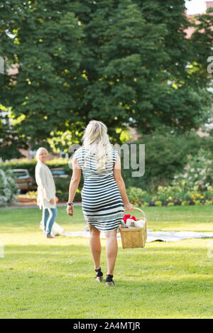 Woman carrying picnic basket Stock Photo