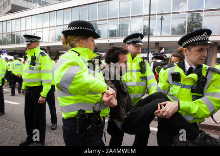 Police made mass arrests as Extinction Rebellion activists defied a London-wide ban on public protests this morning to close off Millbank outside the offices of MI5. Protesting about the lack of food security possible if climate change isn't averted, they parked a caravan in the road and staged a sit in with singing and picnics.