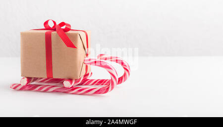 Creative winter sleigh of gift box and candy canes Stock Photo