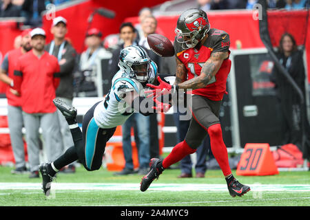 Mike Evans #13 Wide Receiver of Tampa Bay fumbles a catch under pressure from  Elijah Holyfield #21 Running-back of The Carolina Panthers during the NFL game between Carolina Panthers and Tampa Bay Buccaneers at Tottenham Stadium in London, United Kingdom. on the 13 October 2019 Stock Photo