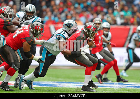Jameis Winston #3 Quarterback of Tampa Bay is sacked by  Gerald McCoy #93 Defensive End of The Carolina Panthers during the NFL game between Carolina Panthers and Tampa Bay Buccaneers at Tottenham Stadium in London, United Kingdom. on the 13 October 2019 Stock Photo