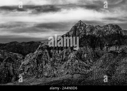 A beautiful view of a desert mountain peak. The monochrome photo shows the sedimentary rock layers for a vivid photo. Stock Photo