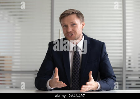 Portrait businessman coach looking at camera, talking, making video call Stock Photo
