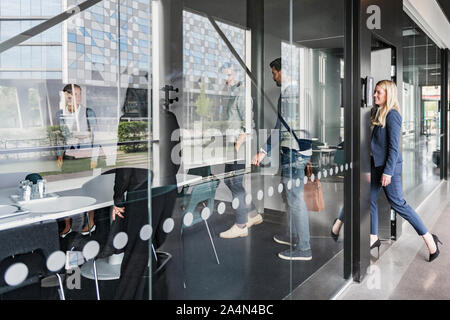 Business people entering board room Stock Photo