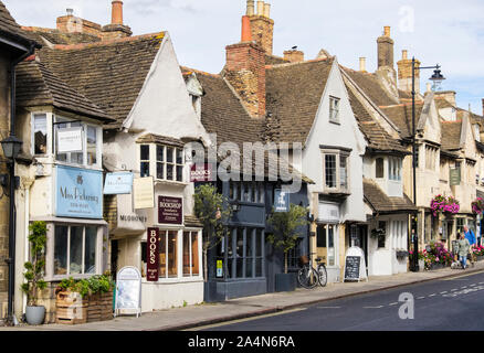 Small shops and cafes in quaint old buildings in historic town centre. St Paul's Street, Stamford, Lincolnshire, England, UK, Britain Stock Photo