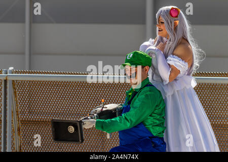 Rome, Italy, 5 April 2019, Comic and Cosplayer event called 'Romix'. Close ups and medium shots of 'Luigi and Princess' in daylight. Famous videogame Stock Photo