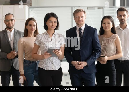 Portrait of successful diverse employees team standing in office Stock Photo
