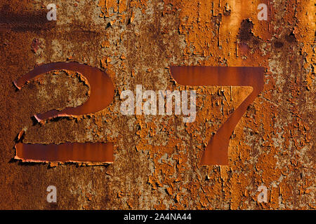 A closeup shot of a rusty number 27 Stock Photo