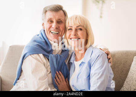 Loving senior couple smiling happily at camera Stock Photo