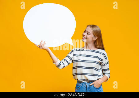 Blank speech bubble in hands of beautiful young girl Stock Photo