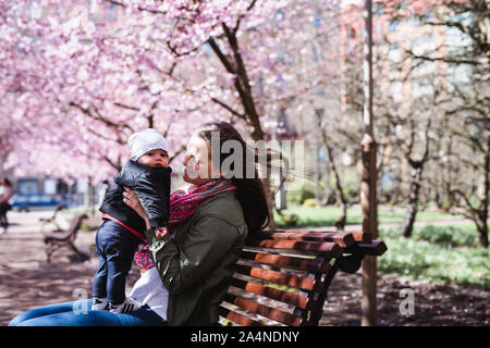 Mother with baby boy in park Stock Photo