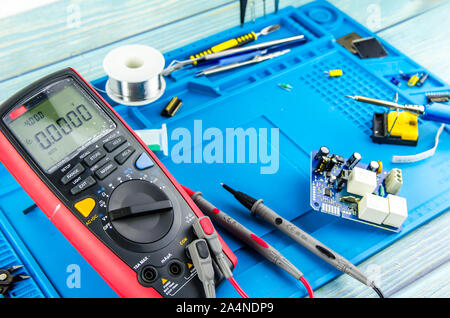 The electrician's workplace. Electronics. Schemes soldering iron. multimeter Stock Photo