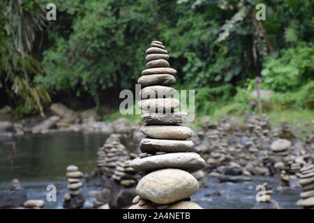 A stack of perfectly balanced, round stones. Symbolising Zen: A focused, peaceful and quiet mind. Shot on the island of Bali - Indonesia. Stock Photo
