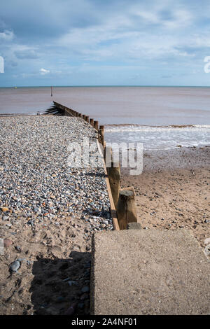 An example of coastal protection with wooden groynes protecting the sand from longshore drift on the beach in Hornsea on the Holderness coastline Stock Photo