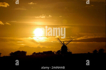 The sun sets behind the Great Haseley windmill in Oxfordshire. Stock Photo