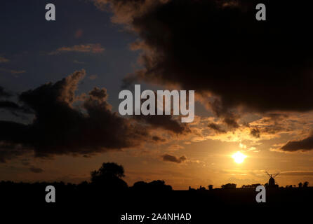 The sun sets behind the Great Haseley windmill in Oxfordshire. Stock Photo