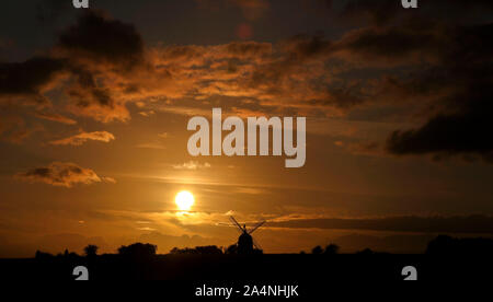 The sun sets behind the Great Haseley windmill in Oxfordshire. Stock Photo