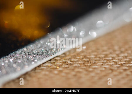 abstract background with copy space for text, textured template image with defocused glitter effect and jute fabric Stock Photo