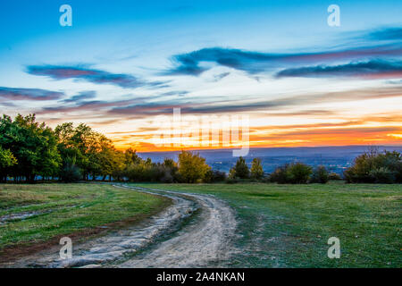 sunset over the field, nature landscape at sunset with orange cloudy sky Stock Photo