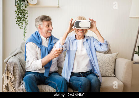 Modern technologies. Elder woman testing VR glasses Stock Photo